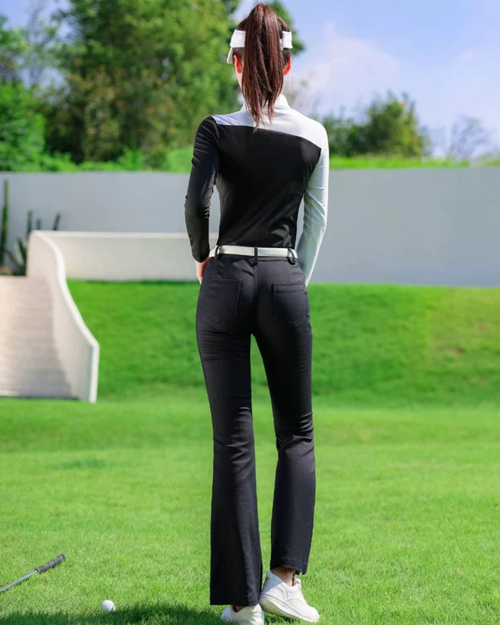 Chamuleの美シルエットフレアゴルフパンツを着用した女性ゴルファー。黒のフレアパンツが脚を長く見せ、ゴルフ場でスタイリッシュな後ろ姿を演出。